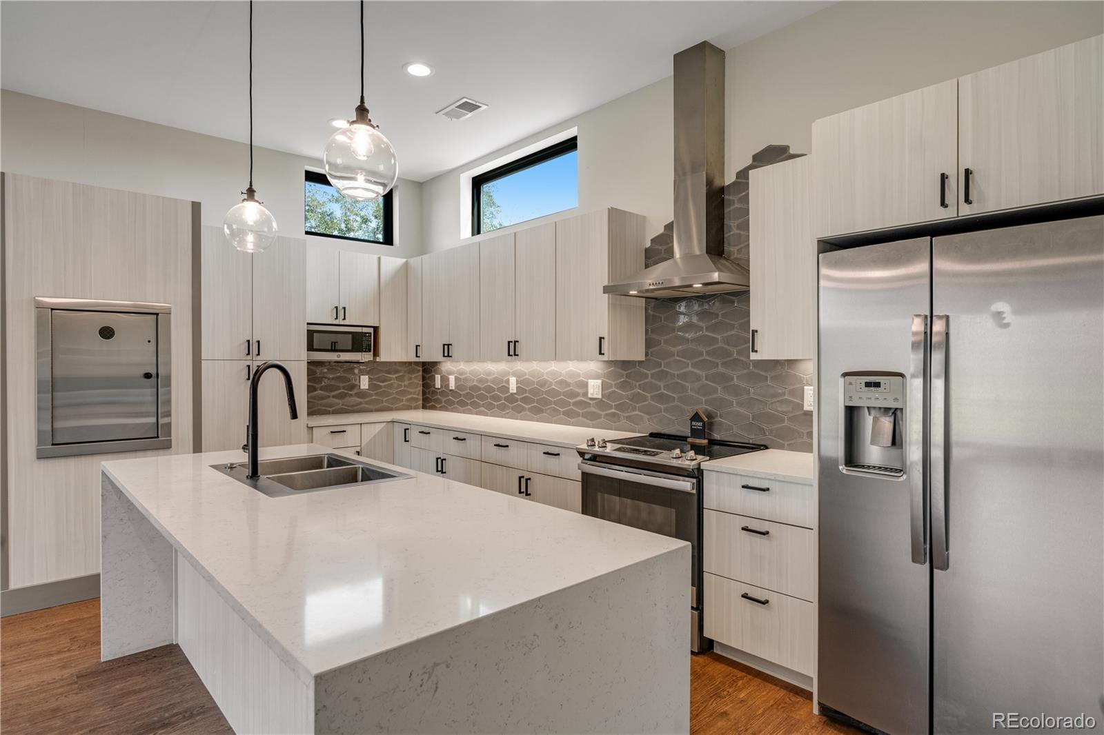 2260 Glenn Street Colorado Springs, CO 80904 - Photo 11 of 45 a kitchen with stainless steel appliances granite countertop a stove refrigerator sink and cabinets