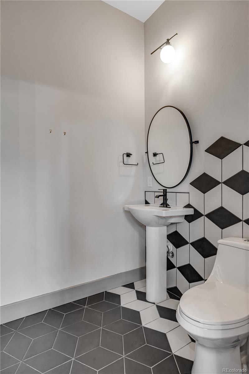 2260 Glenn Street Colorado Springs, CO 80904 - Photo 14 of 45 a bathroom with a sink toilet and a mirror
