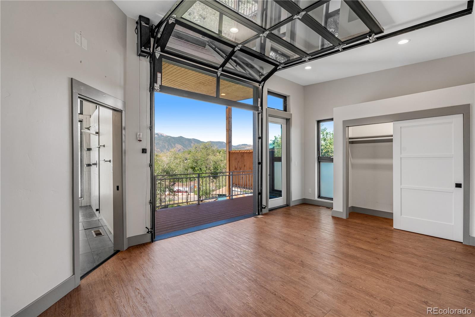 2260 Glenn Street Colorado Springs, CO 80904 - Photo 19 of 45 a view of an empty room with wooden floor and a window