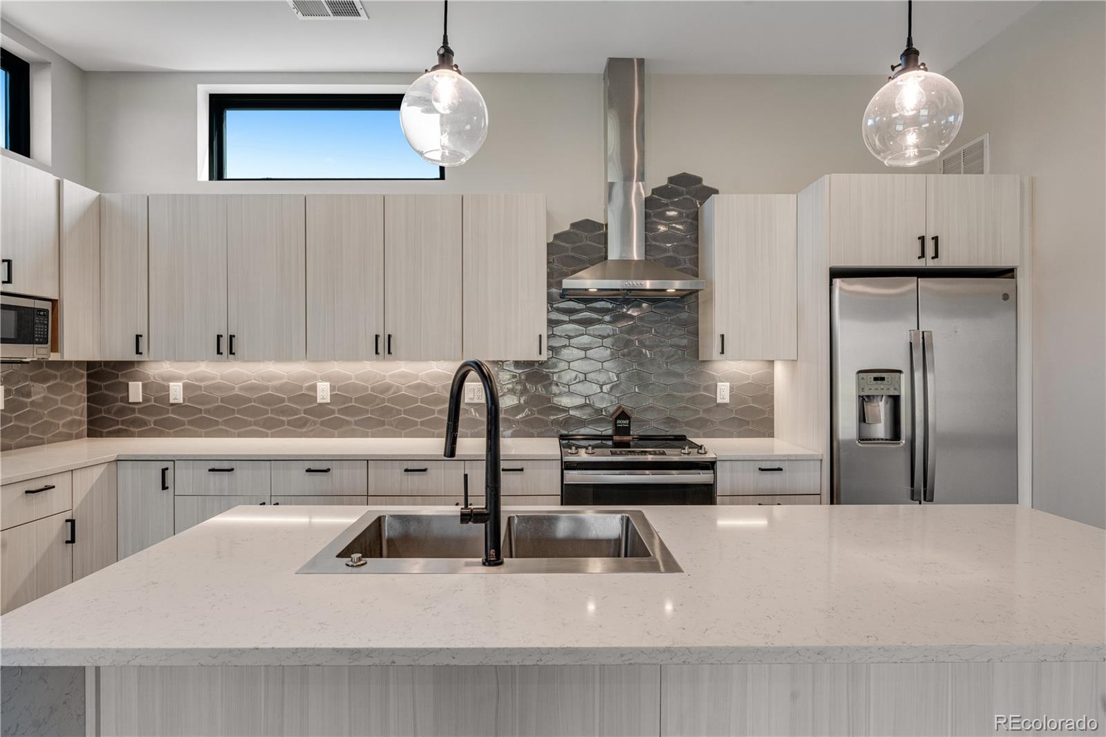 2260 Glenn Street Colorado Springs, CO 80904 - Photo 2 of 45 a kitchen with cabinets and chandelier