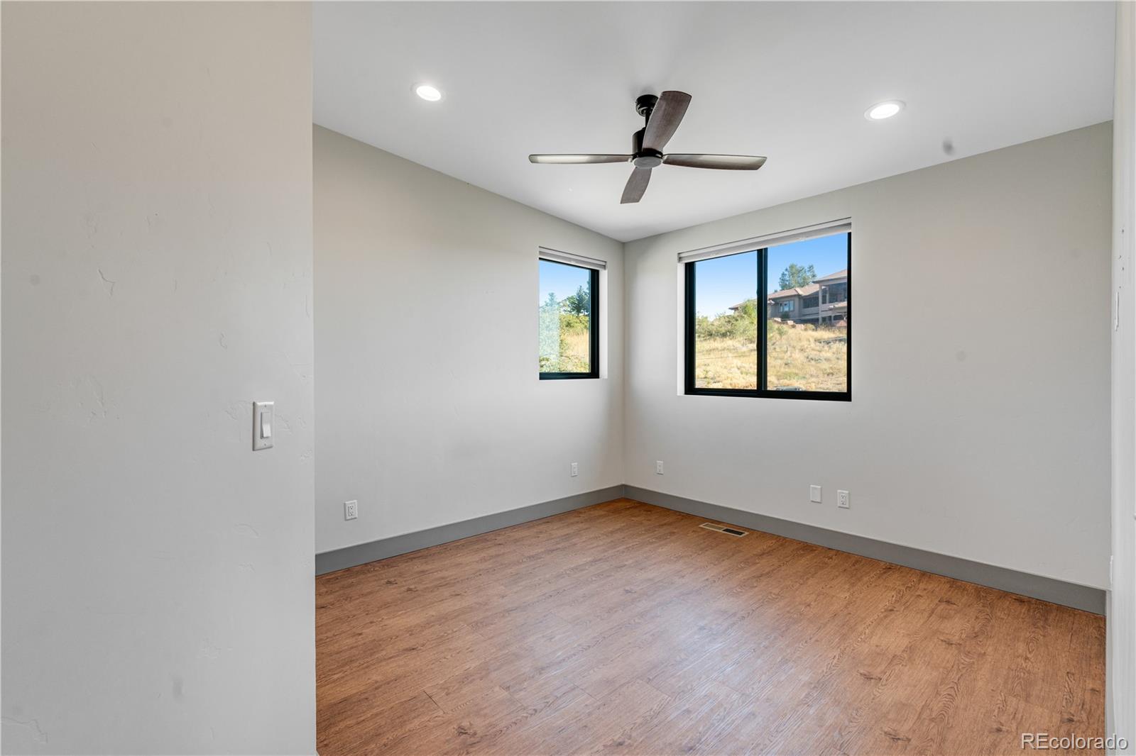 2260 Glenn Street Colorado Springs, CO 80904 - Photo 26 of 45 a view of empty room with wooden floor and fan