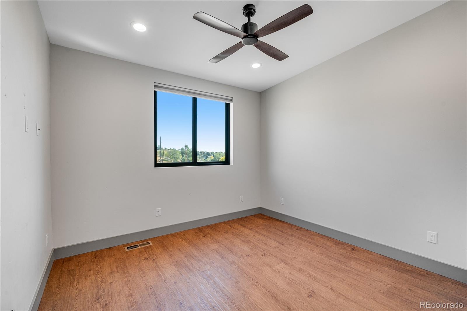 2260 Glenn Street Colorado Springs, CO 80904 - Photo 27 of 45 an empty room with a window and a ceiling fan
