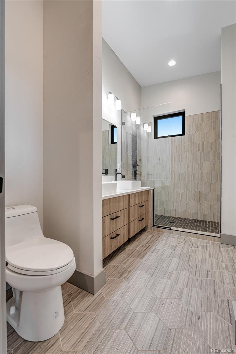2260 Glenn Street Colorado Springs, CO 80904 - Photo 29 of 45 a bathroom with a toilet sink and mirror