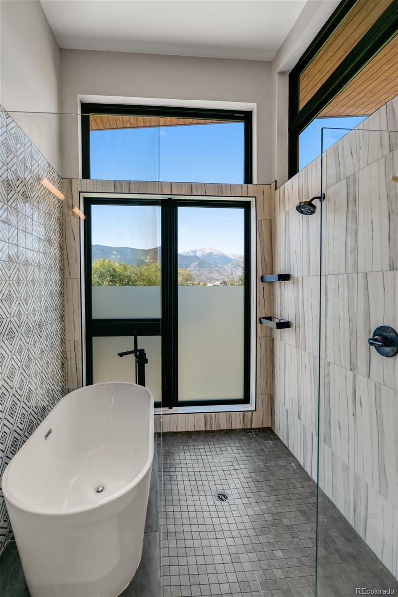 2260 Glenn Street Colorado Springs, CO 80904 - Photo 30 of 45 a bathroom with a bathtub and a shower