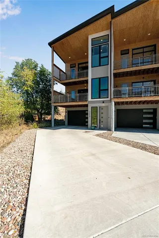 a view of a kitchen with refrigerator and wooden floor