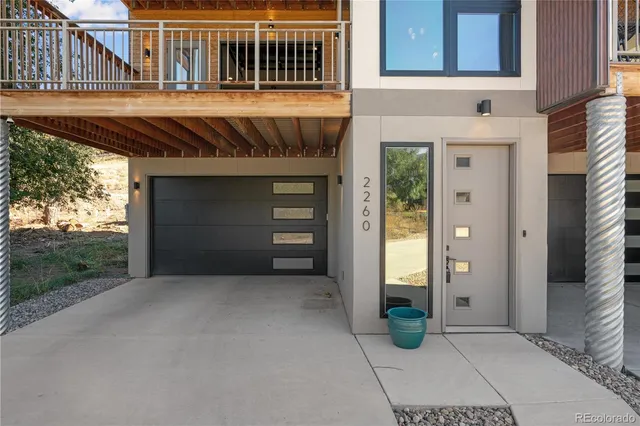 a large kitchen with stainless steel appliances a refrigerator and wooden floor