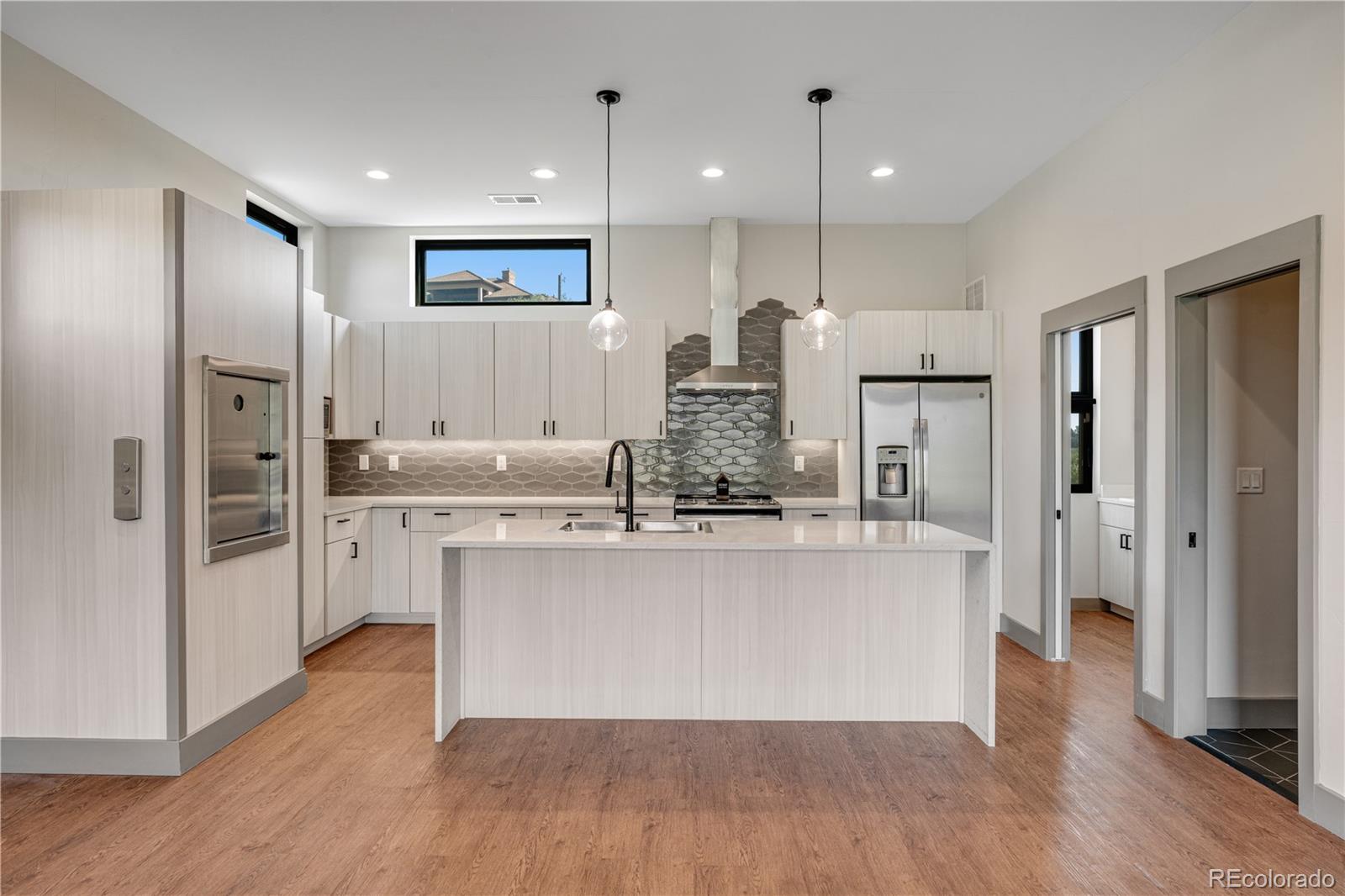 2260 Glenn Street Colorado Springs, CO 80904 - Photo 10 of 45 a large kitchen with stainless steel appliances a refrigerator and wooden floor