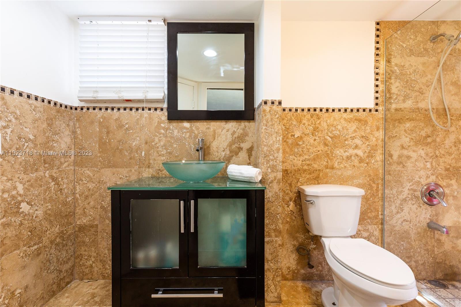 2743 Southwest 32nd Avenue Miami, FL 33133 - Photo 16 of 33 a bathroom with a toilet a sink and mirror