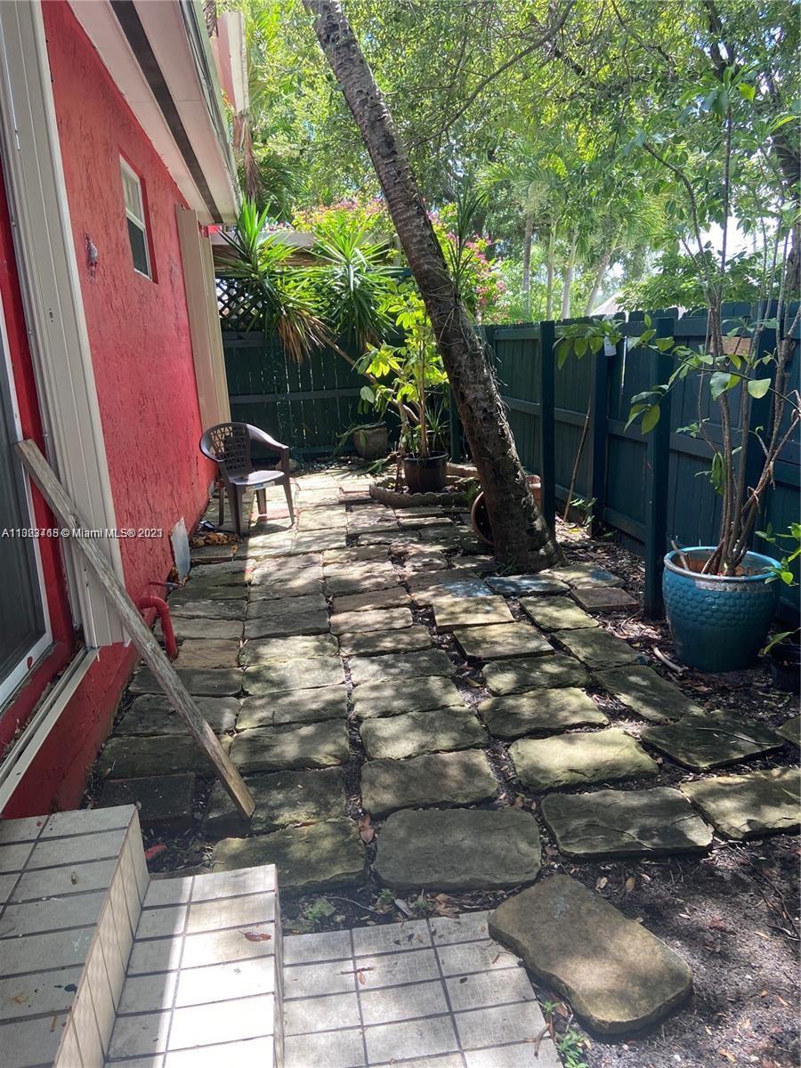 2743 Southwest 32nd Avenue Miami, FL 33133 - Photo 24 of 33 a view of a backyard with table and chairs and potted plants