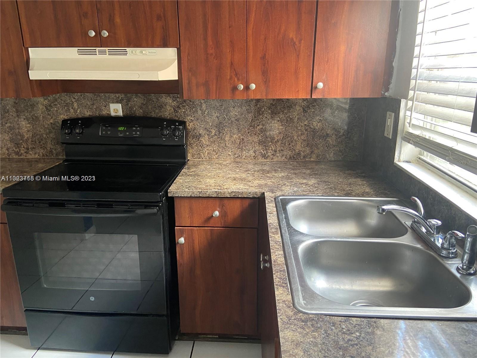 2743 Southwest 32nd Avenue Miami, FL 33133 - Photo 31 of 33 a kitchen with a sink and a stove