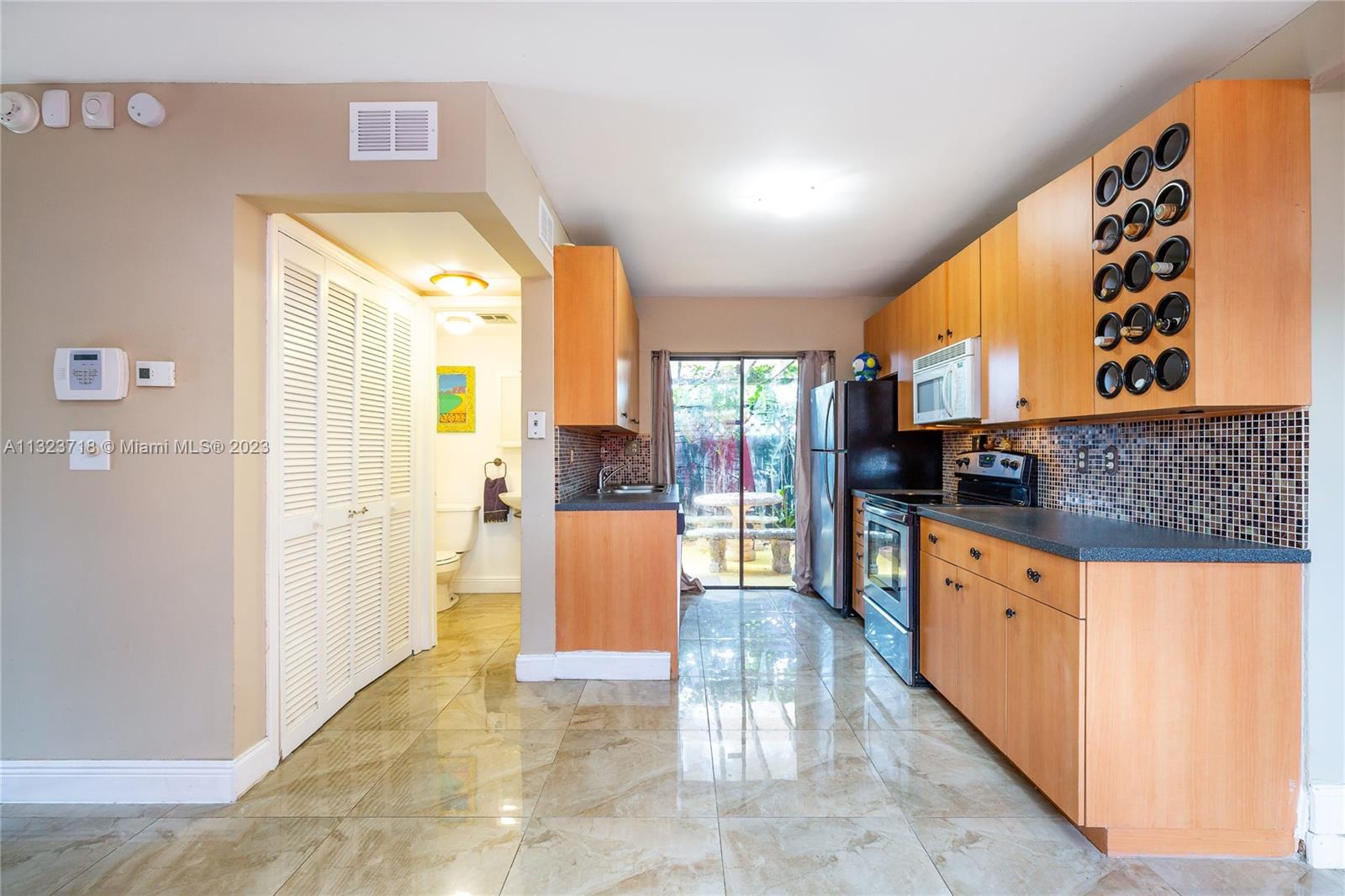 2743 Southwest 32nd Avenue Miami, FL 33133 - Photo 8 of 33 a kitchen with stainless steel appliances kitchen island granite countertop a refrigerator and a stove top oven