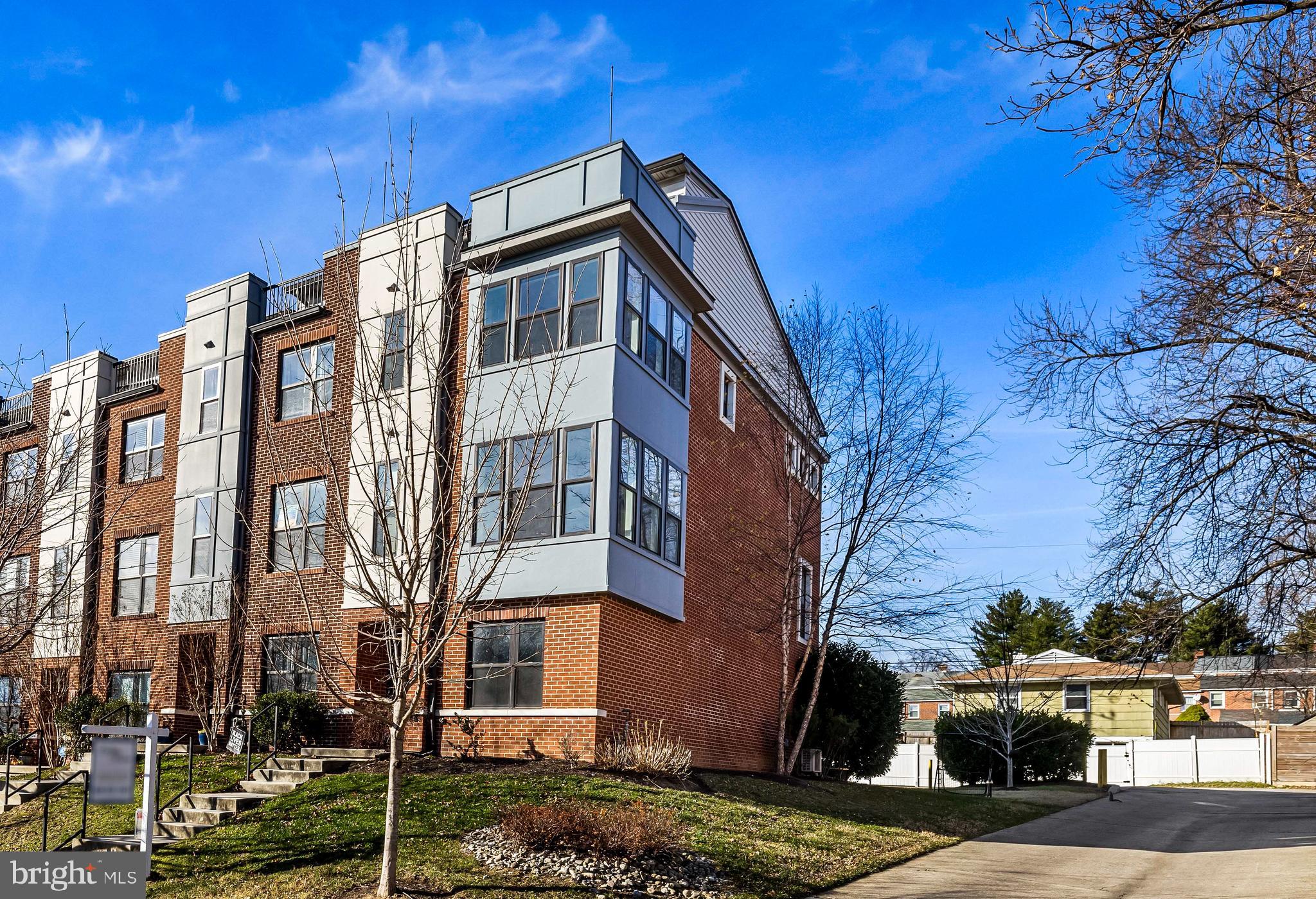 a front view of a residential apartment building with a yard