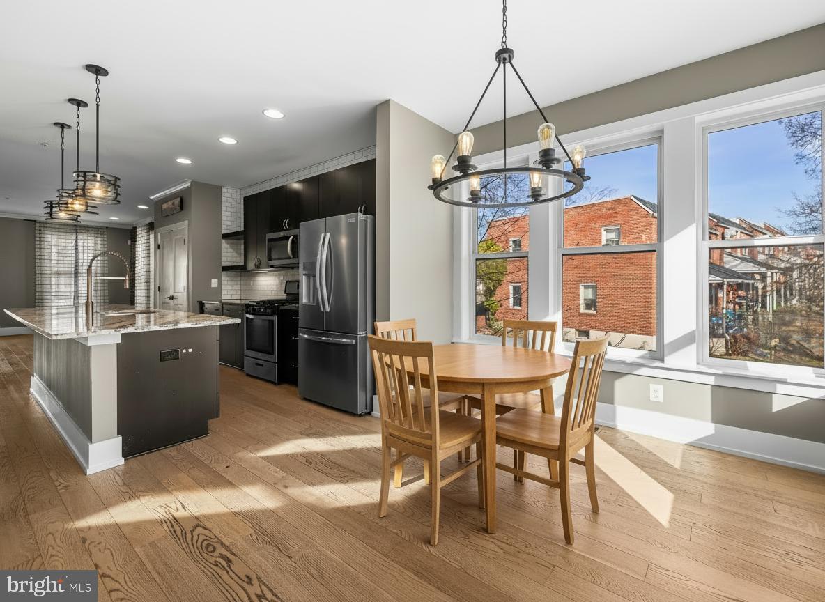 1456 Redfern Avenue Baltimore, MD 21211 - Photo 16 of 44 a view of a dining room with furniture window and wooden floor