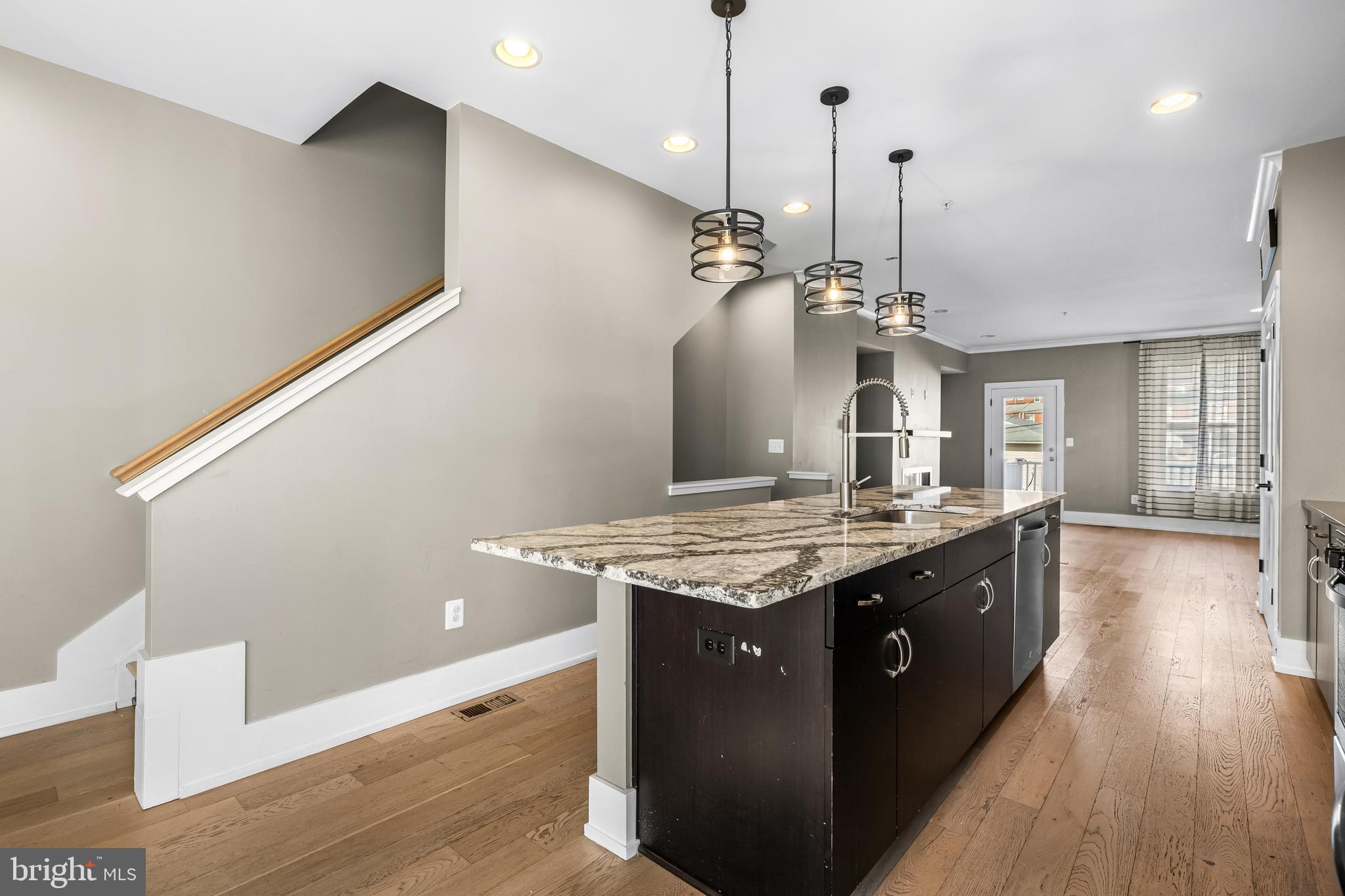 1456 Redfern Avenue Baltimore, MD 21211 - Photo 21 of 44 a kitchen with granite countertop a stove and a wooden floor