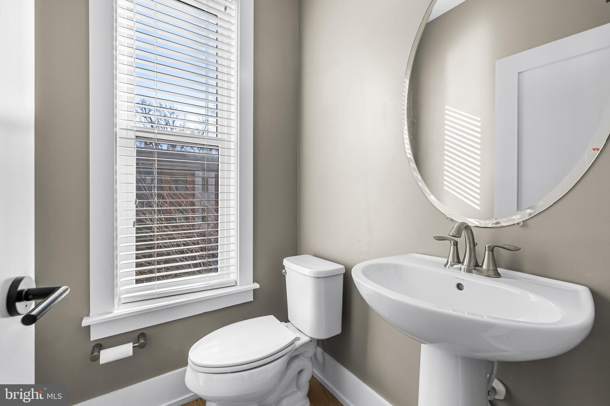 1456 Redfern Avenue Baltimore, MD 21211 - Photo 22 of 44 a bathroom with a sink a toilet and a mirror
