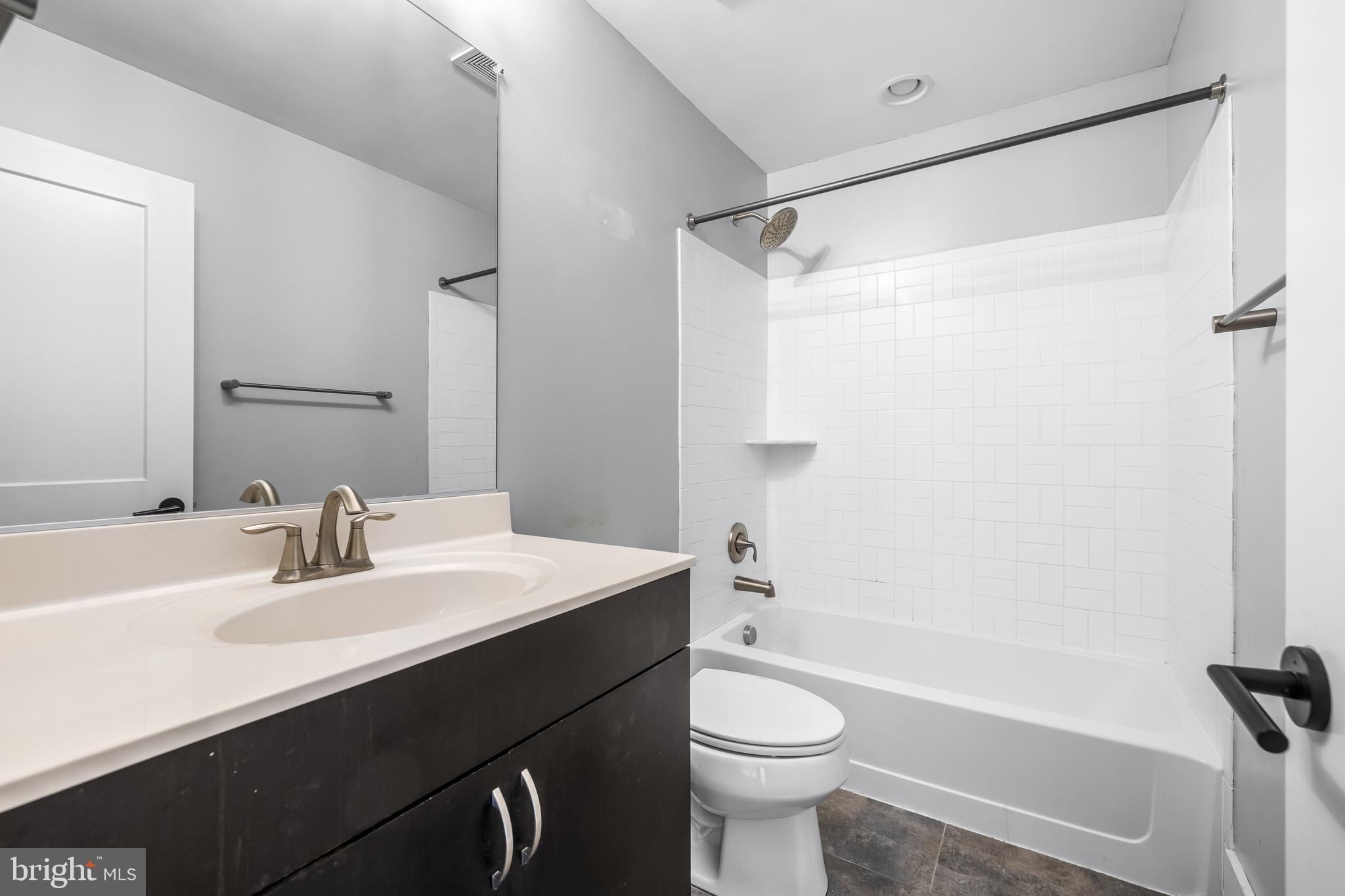 1456 Redfern Avenue Baltimore, MD 21211 - Photo 32 of 44 a bathroom with a sink mirror toilet and bathtub