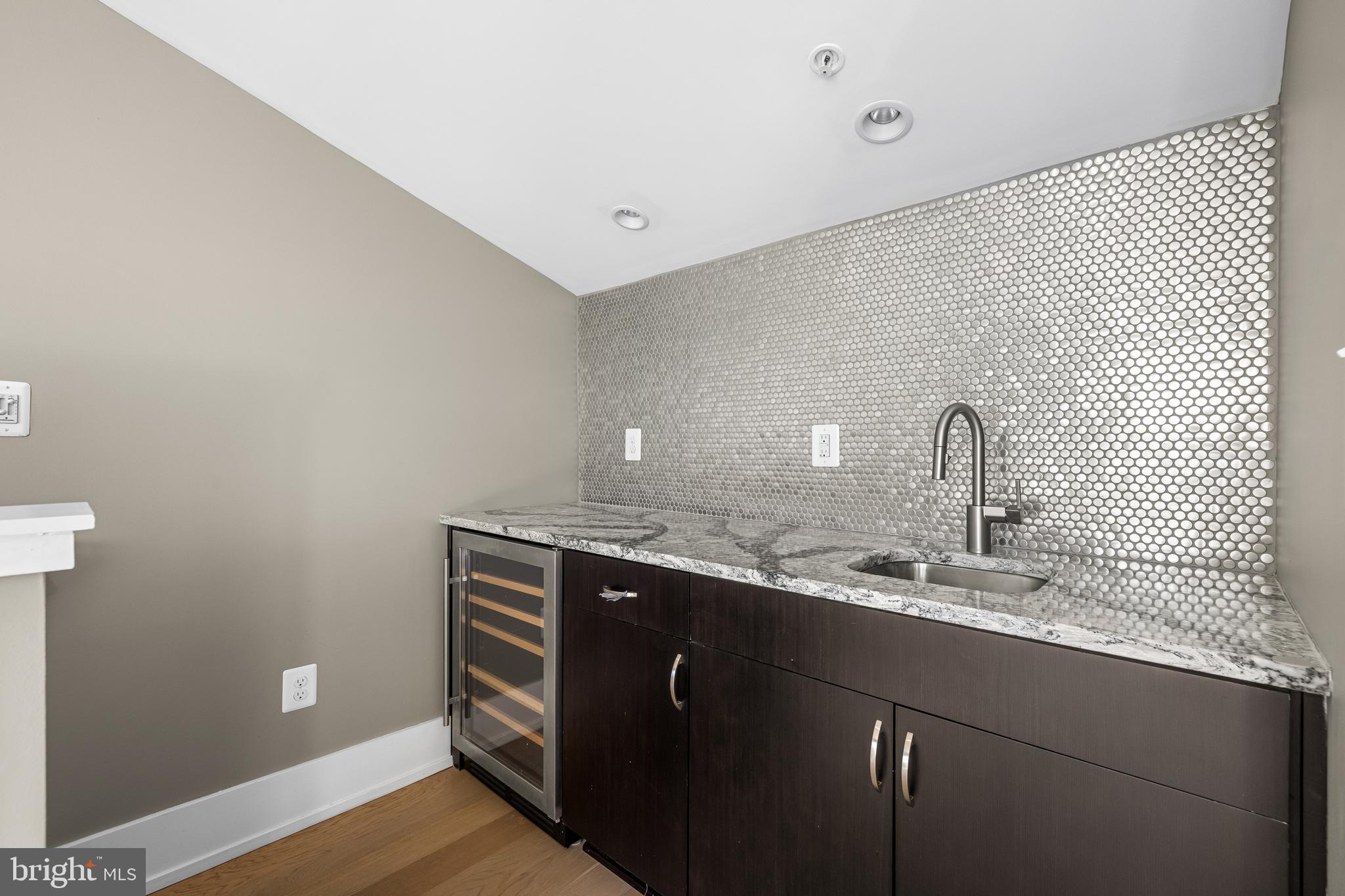 1456 Redfern Avenue Baltimore, MD 21211 - Photo 37 of 44 a bathroom with a granite countertop sink and a mirror