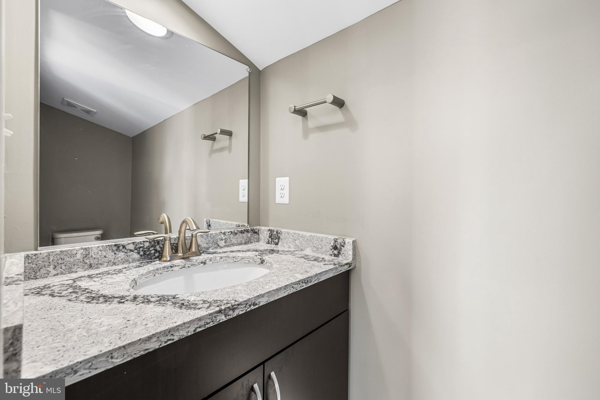 1456 Redfern Avenue Baltimore, MD 21211 - Photo 38 of 44 a bathroom with a granite countertop sink and a mirror