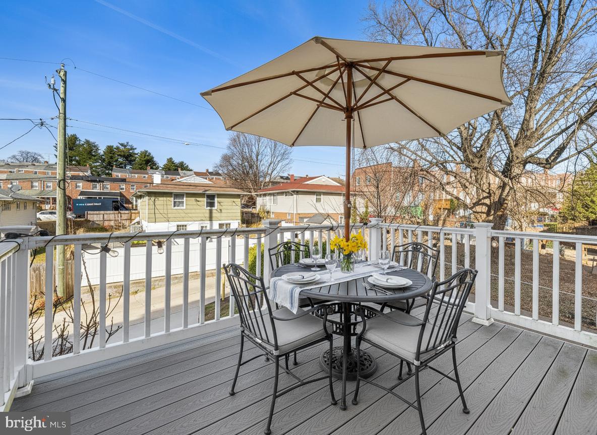 1456 Redfern Avenue Baltimore, MD 21211 - Photo 42 of 44 a view of a balcony with chairs and wooden floor
