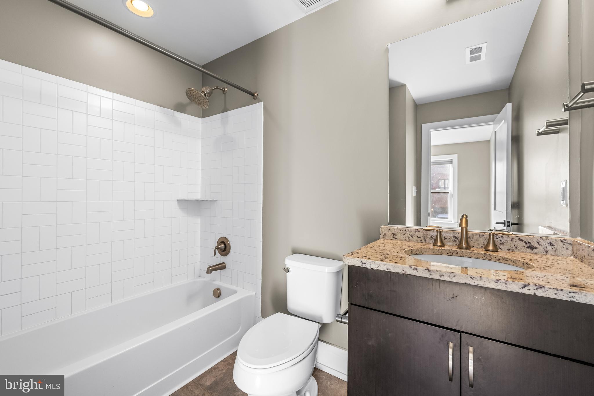1456 Redfern Avenue Baltimore, MD 21211 - Photo 8 of 44 a bathroom with a granite countertop sink toilet tub and shower