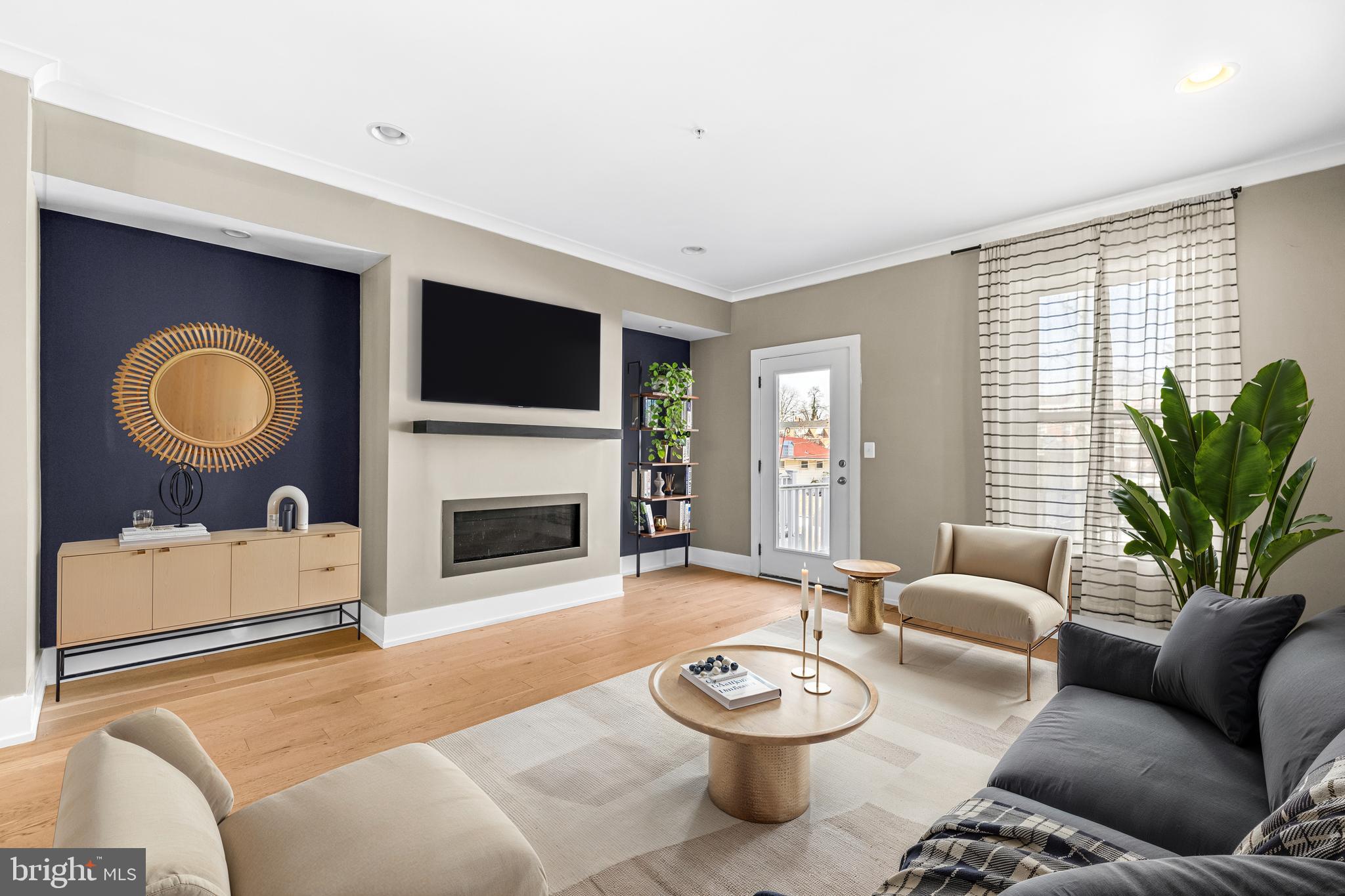 1456 Redfern Avenue Baltimore, MD 21211 - Photo 10 of 44 a living room with furniture a fireplace and a flat screen tv