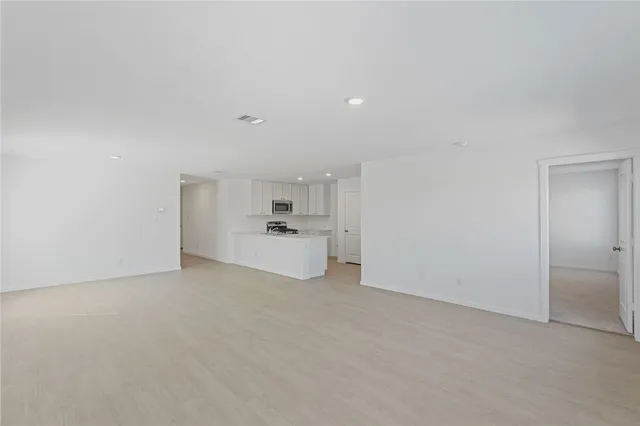 a view of a kitchen with white cabinets