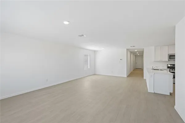 a view of a kitchen with a sink and a refrigerator