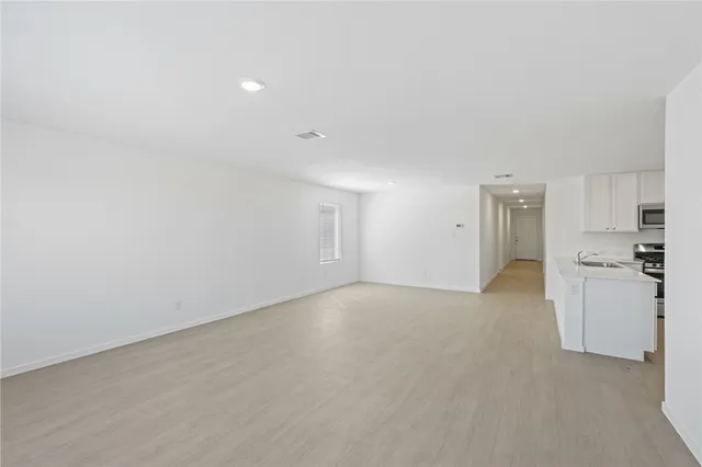 a view of a kitchen with a sink and a refrigerator