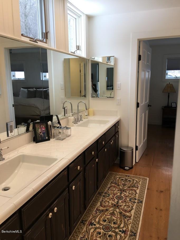 5 Jericho Road Hancock, MA 01267 - Photo 17 of 38 a bathroom with a double vanity sink and a mirror