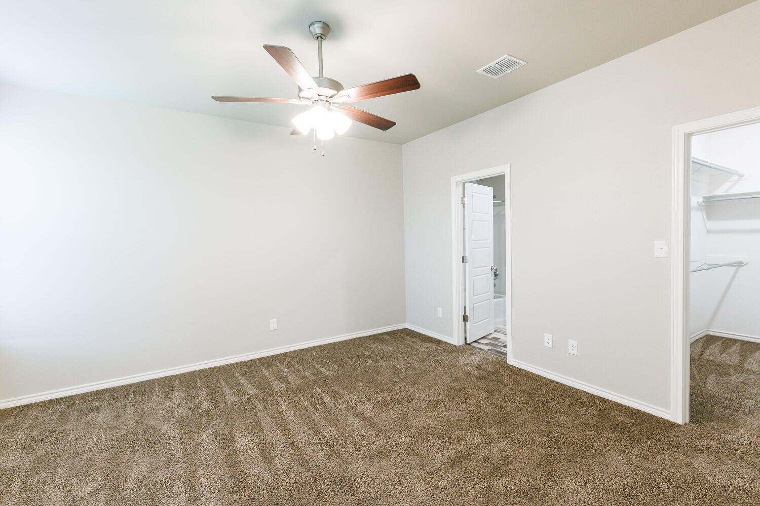 6956 12th Street Lubbock, TX 79416 - Photo 22 of 43 an empty room with a ceiling fan and a window