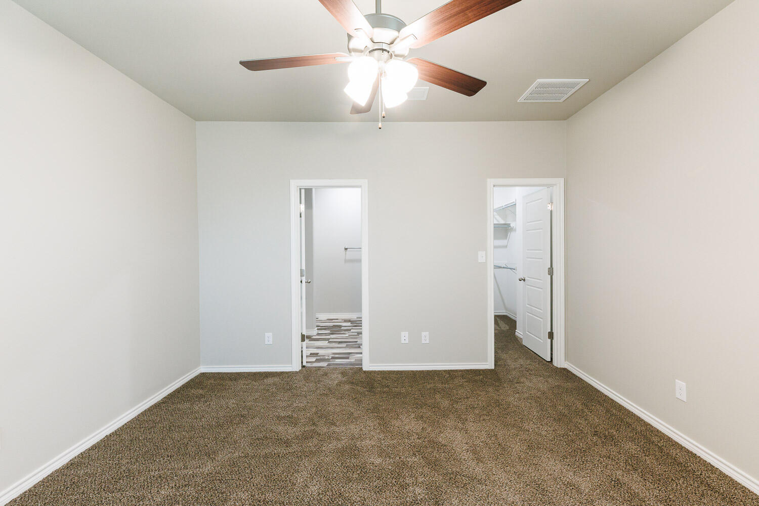 6956 12th Street Lubbock, TX 79416 - Photo 23 of 43 an empty room with closet and a chandelier fan
