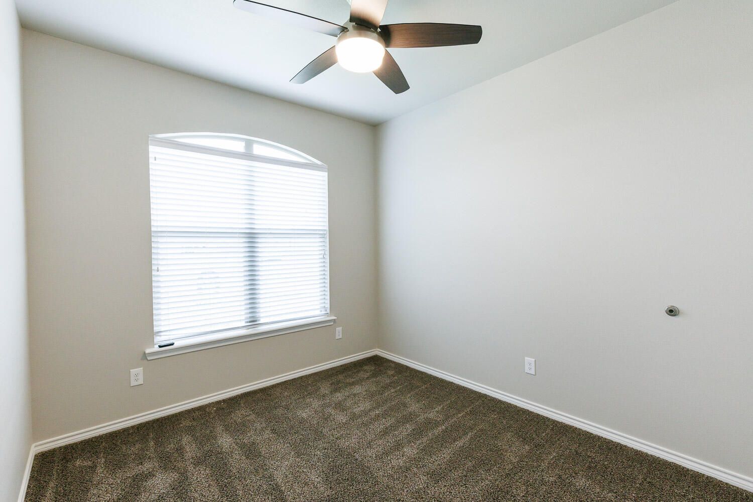 6956 12th Street Lubbock, TX 79416 - Photo 31 of 43 an empty room with a window and a fan