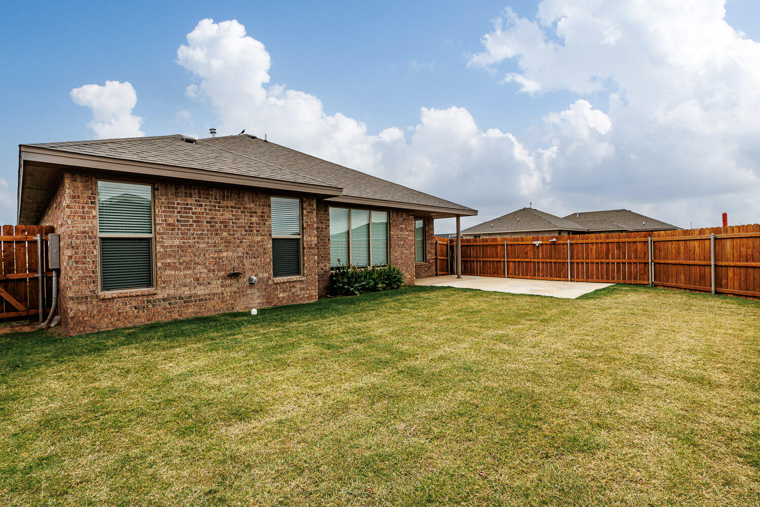 6956 12th Street Lubbock, TX 79416 - Photo 39 of 43 a front view of a house with a garden