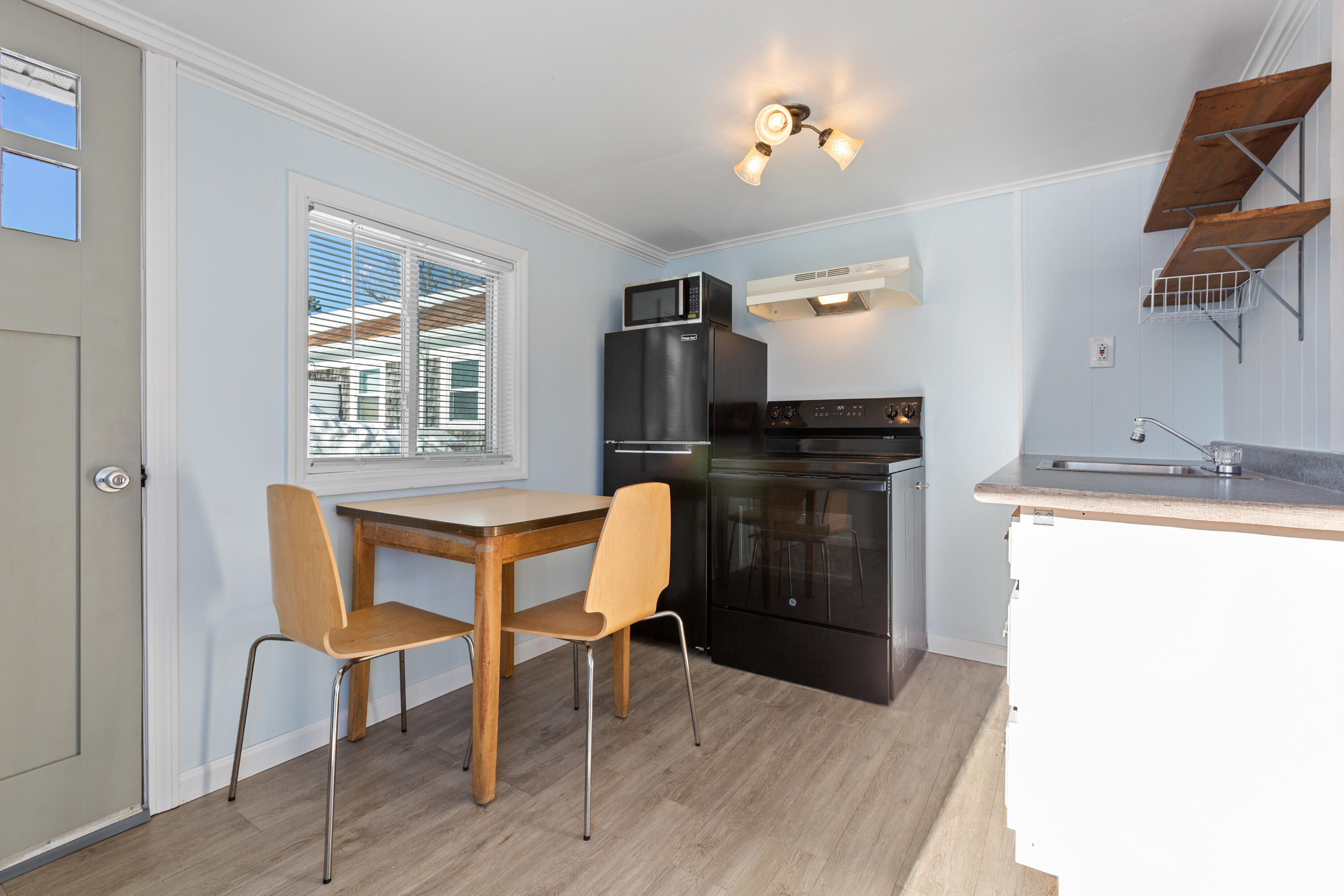 183 Captain Chase Road Dennis Port, MA 02639 - Photo 11 of 44 a kitchen with granite countertop a stove refrigerator and microwave