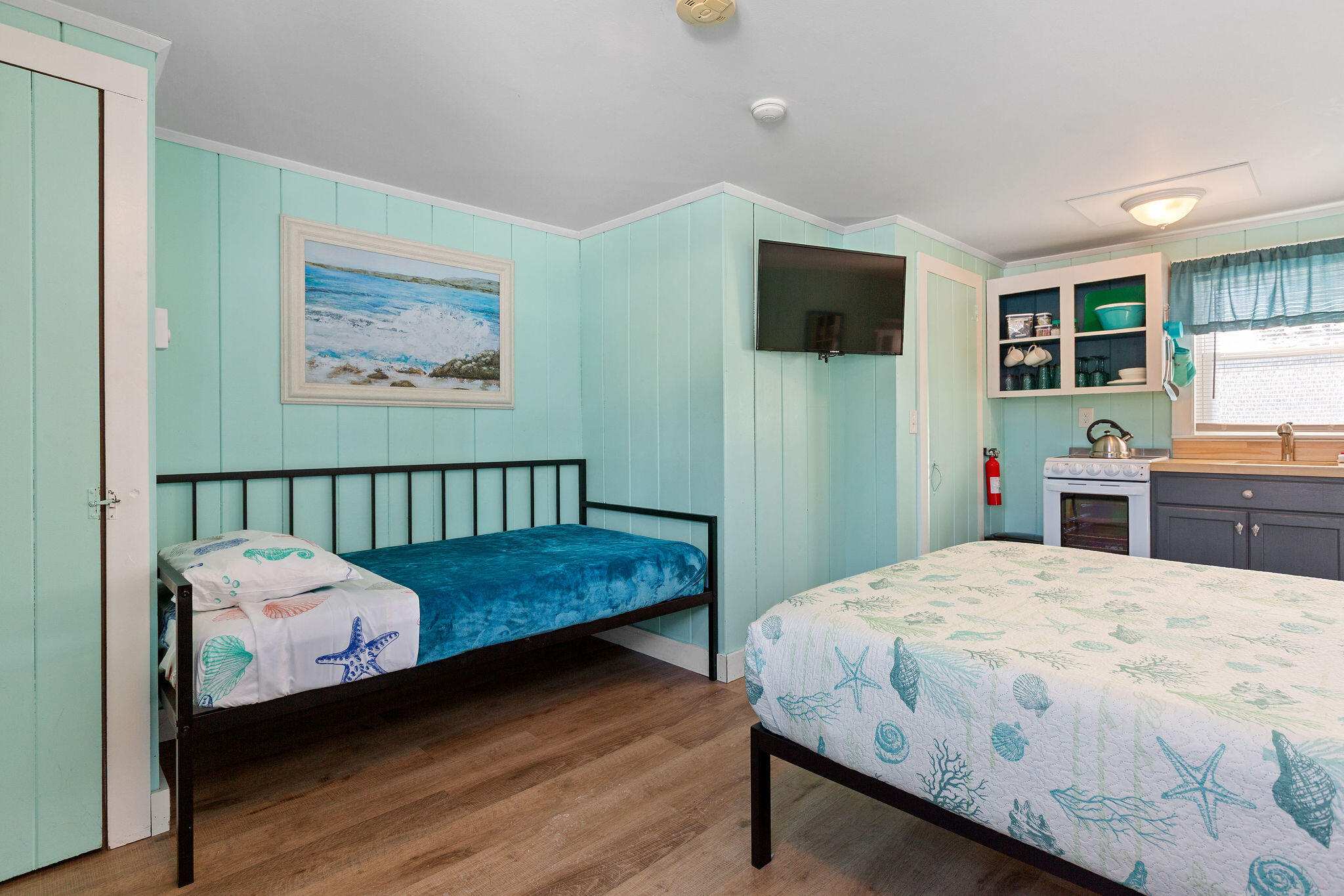 183 Captain Chase Road Dennis Port, MA 02639 - Photo 30 of 44 a bed sitting in a bedroom and a flat tv screen
