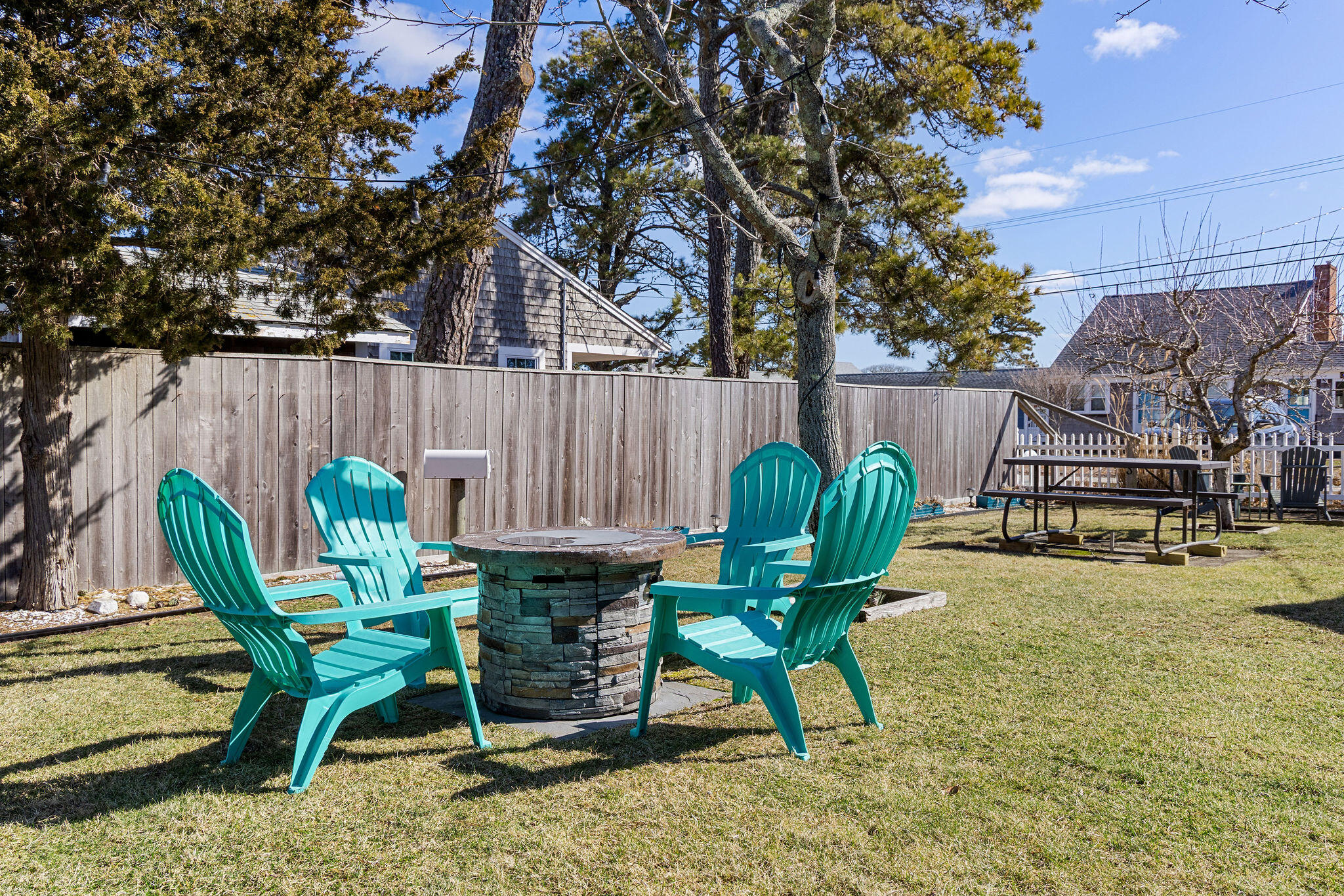 183 Captain Chase Road Dennis Port, MA 02639 - Photo 34 of 44 a view of a chairs and table in backyard