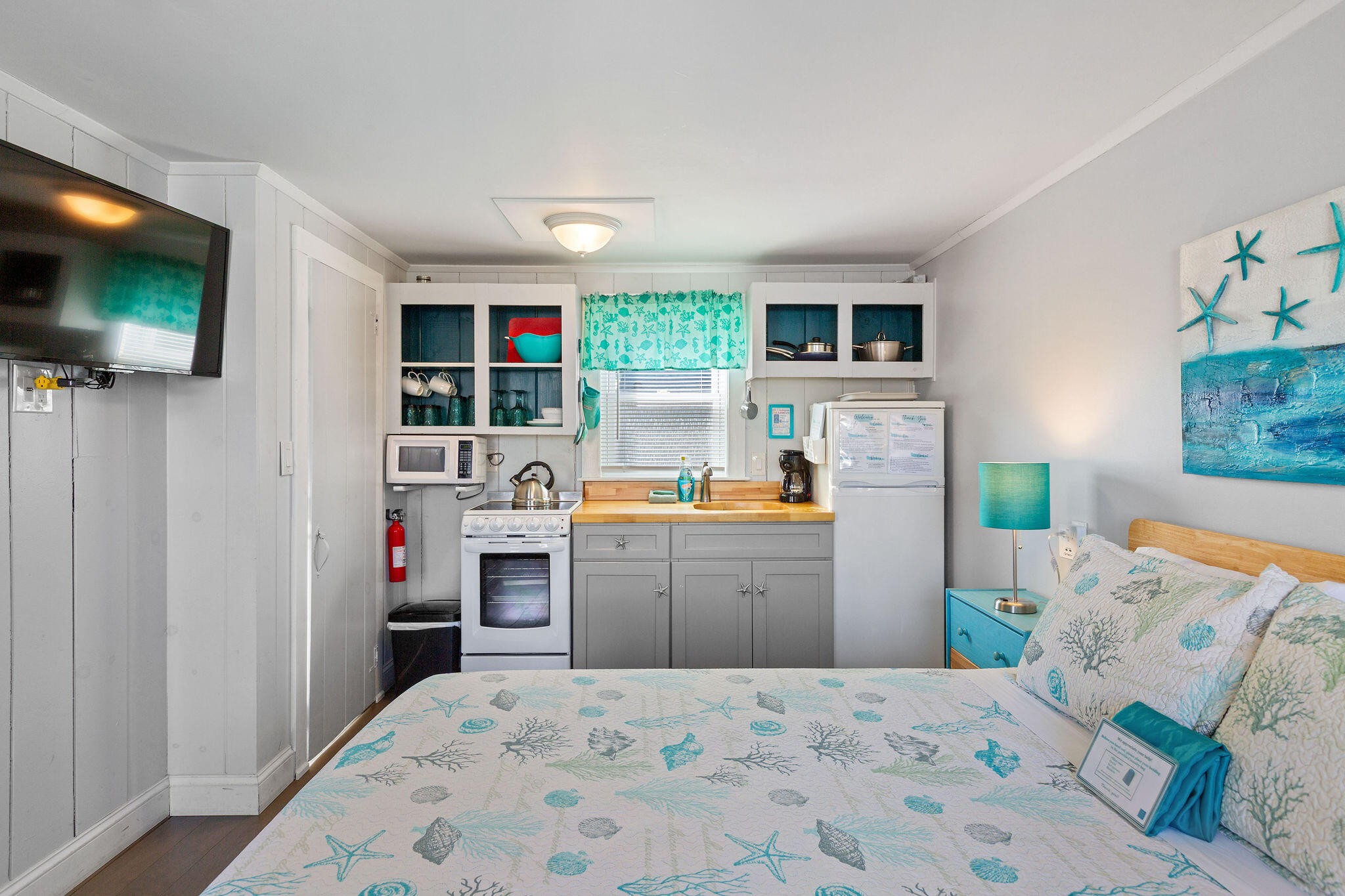 183 Captain Chase Road Dennis Port, MA 02639 - Photo 36 of 44 a bed room with a bed a television and a window