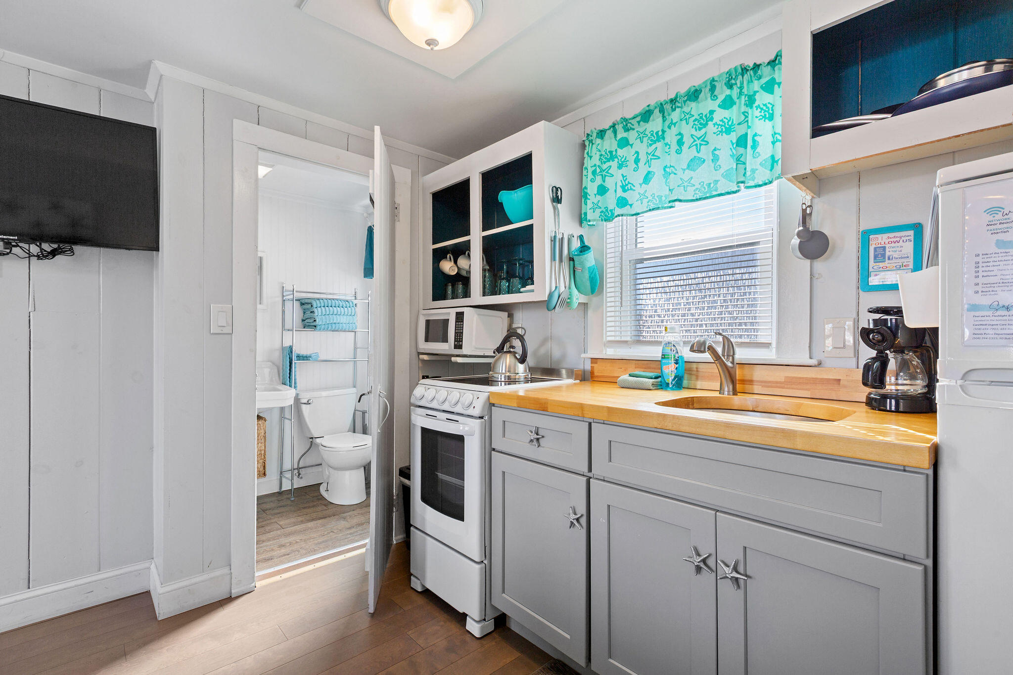 183 Captain Chase Road Dennis Port, MA 02639 - Photo 40 of 44 a en suite bathroom with a granite countertop sink and a mirror