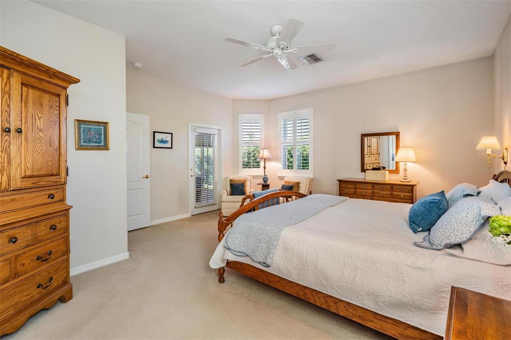 1630 Lakestone Drive Trinity, FL 34655 - Photo 13 of 49 a bedroom with a bed and a chandelier