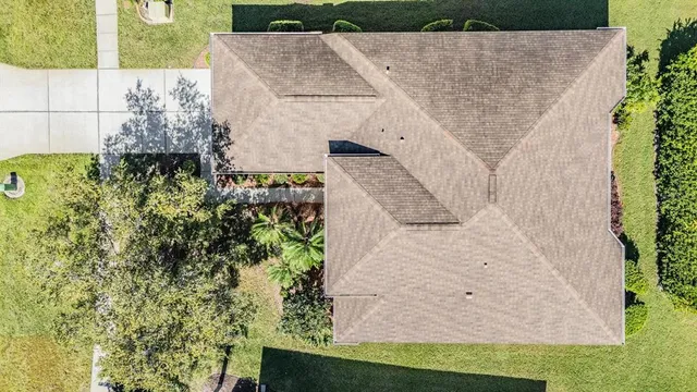 an aerial view of a house with a yard
