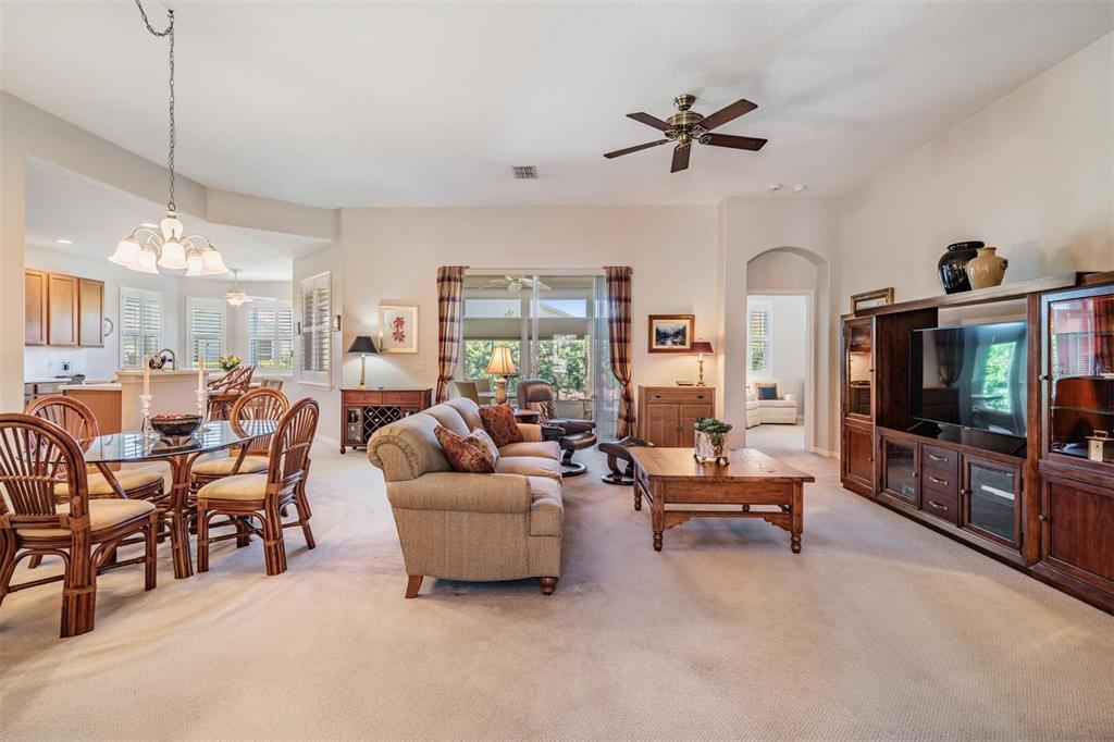 1630 Lakestone Drive Trinity, FL 34655 - Photo 3 of 49 a living room with furniture a flat screen tv and a large window