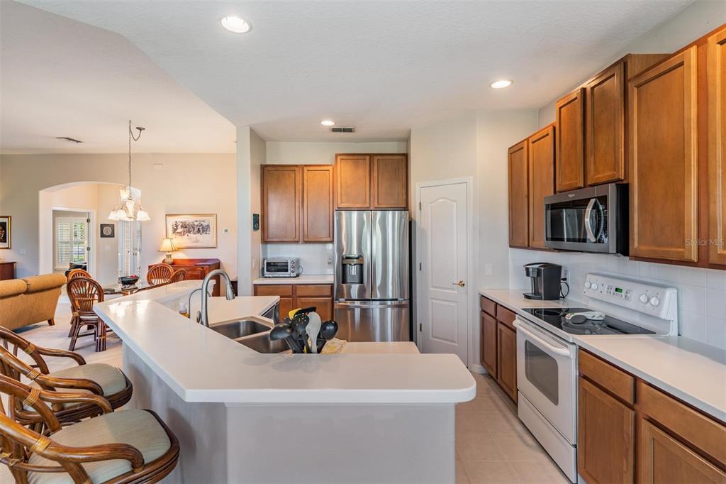 1630 Lakestone Drive Trinity, FL 34655 - Photo 7 of 49 a kitchen that has a sink a stove and chairs