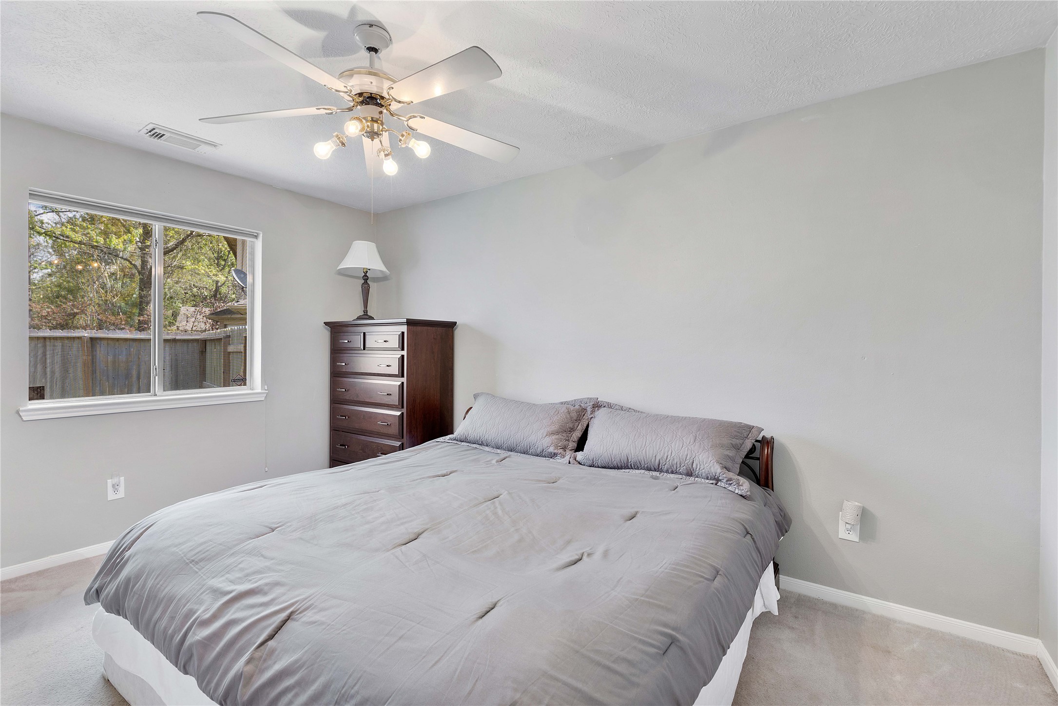 1707 Moston Drive Spring, TX 77386 - Photo 27 of 41 a bedroom with a large bed and a chandelier