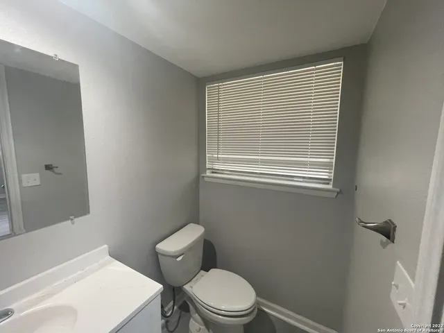 a white toilet sitting next to a bathroom sink