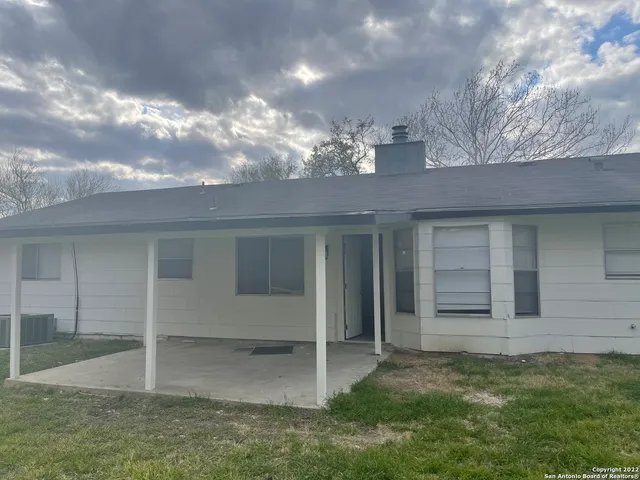 a view of a house with a yard and garage