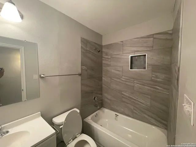 a bathroom with a toilet and a bathtub