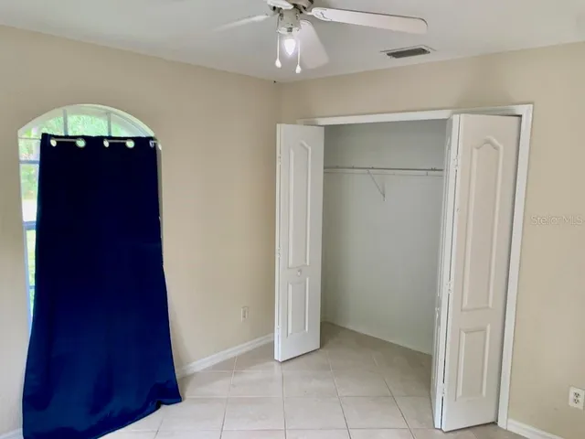 a bathroom with a granite countertop sink a toilet and mirror