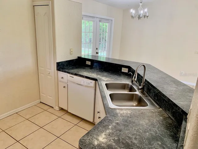 a view of a sink and dishwasher with wooden floor