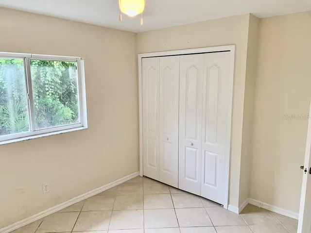 a spacious bathroom with a granite countertop sink a toilet and shower
