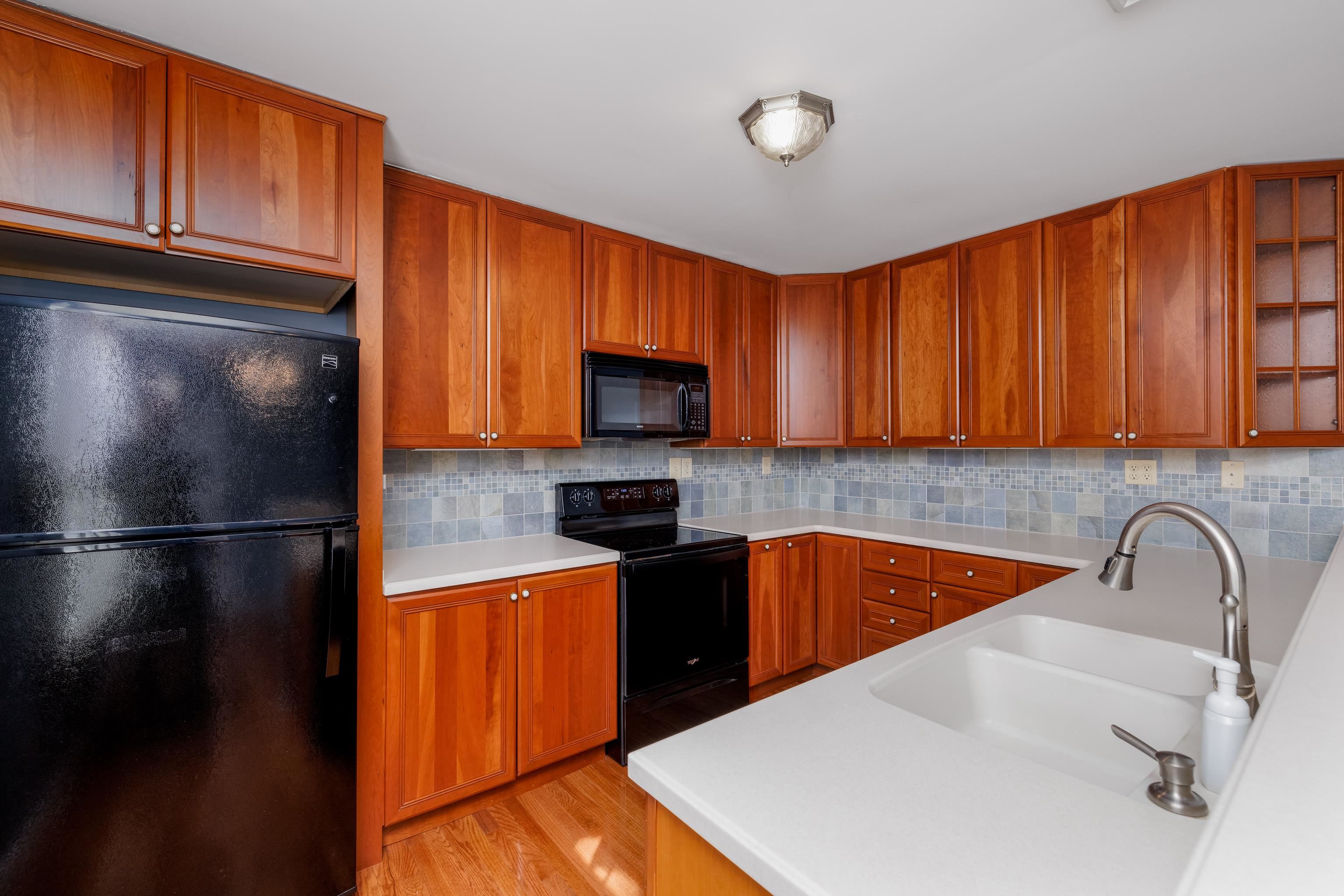 880 Honeysuckle Road Erma, NJ 08204 - Photo 11 of 31 a kitchen with stainless steel appliances granite countertop a refrigerator sink and cabinets